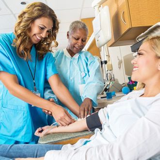 Medical Assistants helping a patient