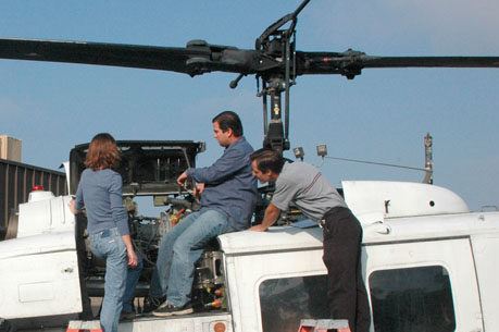 Group of maintenance workers work on helicopter