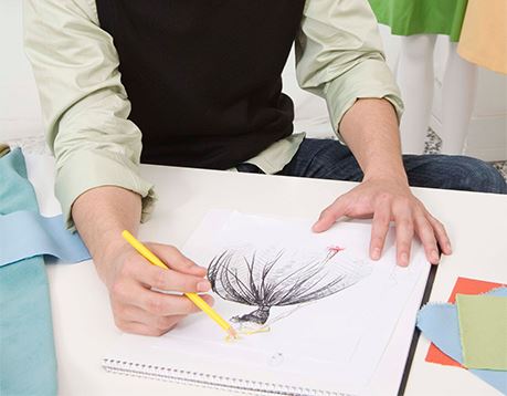 Man works on fashion design drawing