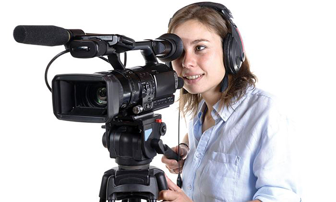 Woman in white shirt operates a camera and mic set