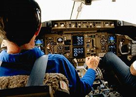 Male pilot in blue shirt flies plane