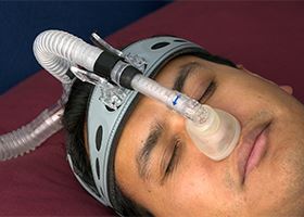 Male patient sleeps with sleep apnea mask