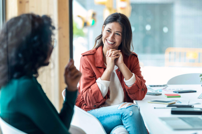 career-mentoring-two-women-talking-and smiling