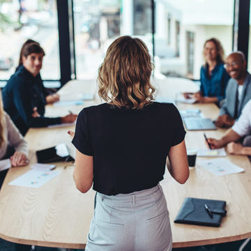 A woman giving a presentation to a group.