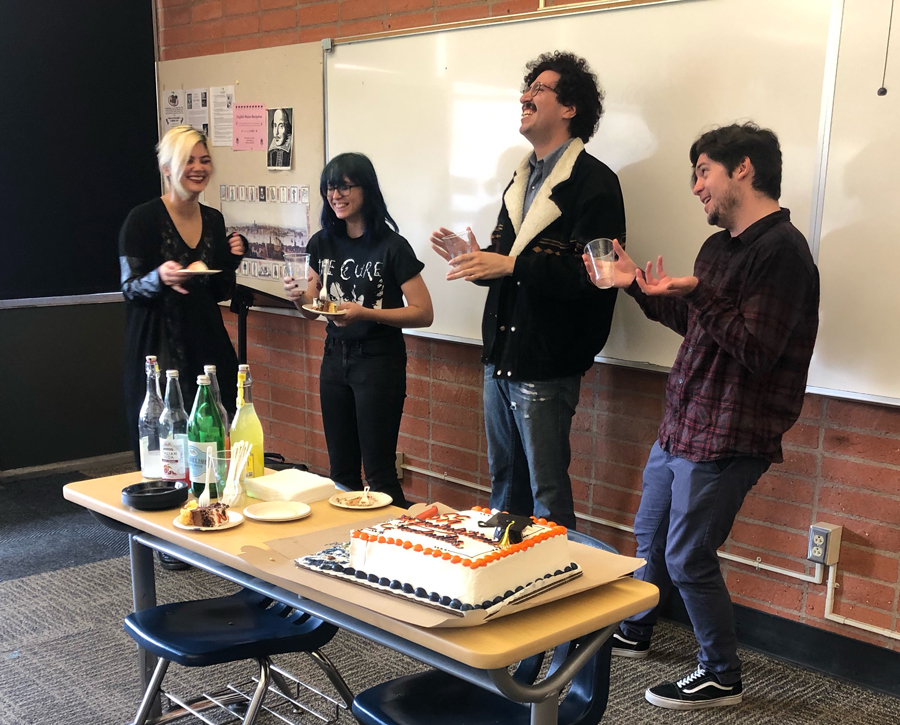 Four Students Eating Cake and Laughing at the English Majors Graduation Event 
