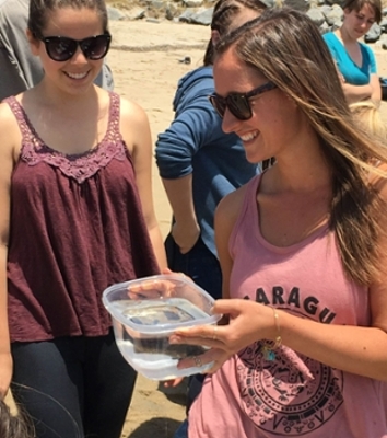 Students releasing white sea bass