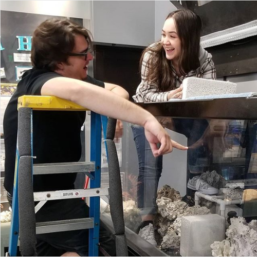 Two students working together at OCC aquarium