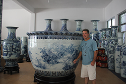 Kevin-Myers in Jingdezhen, China standing next to a giant vase