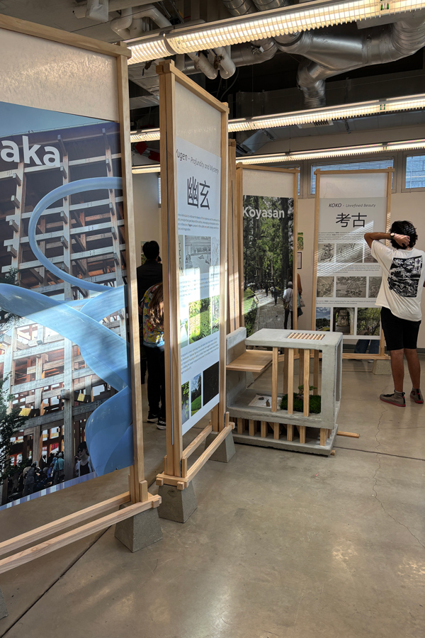 Exhibition space displaying information panels about different Japanese locations, including Koyasan and Yukigaya, along with a contemporary seating structure.