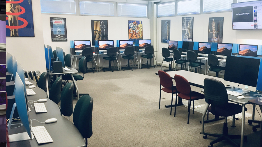 Post Production Room filled with tables, chairs, and computers