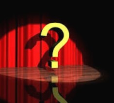 A question mark onstage in the spotlight