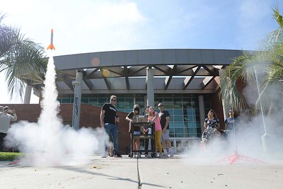 Toy rockets launching in front of the library