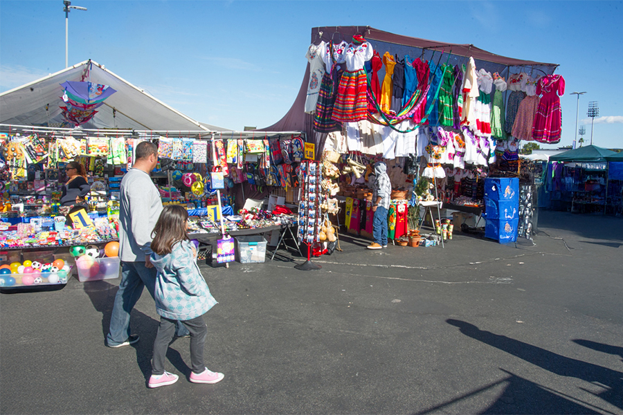 A family walking around the swap meet.