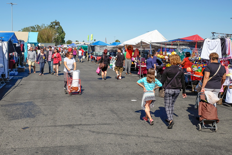 A crowd of people walking the rows of vendors.