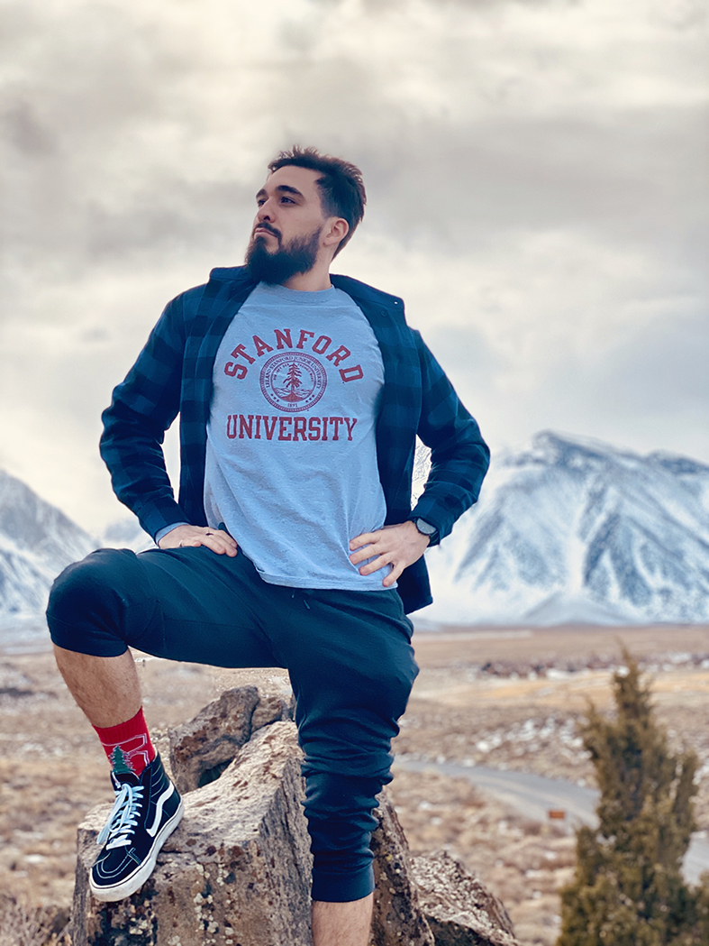 austin salcedo posing on mountain wearing a stanford shirt