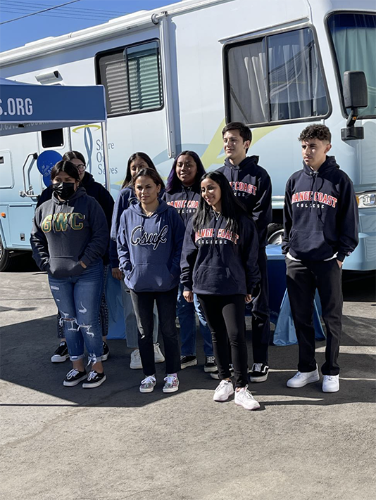 photo of group of high school seniors wearing various college sweatshirts