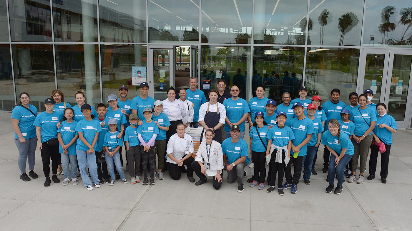 photograph of volunteers and occ faculty wearing matching blue shirts and standing in front of college center 