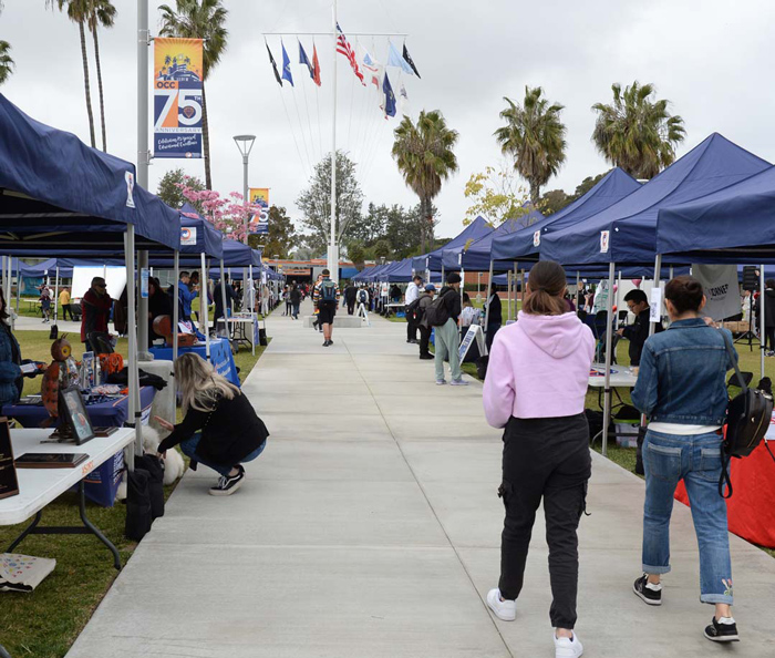 Students walking on campus during an event.