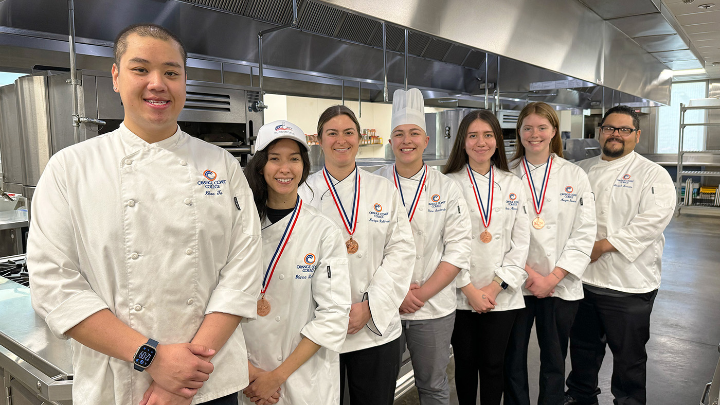 a group of students wearing white chef uniforms