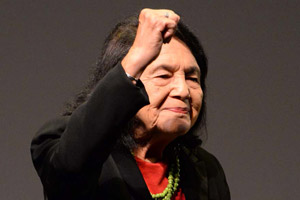 Dolores Huerta holding a fist in the air