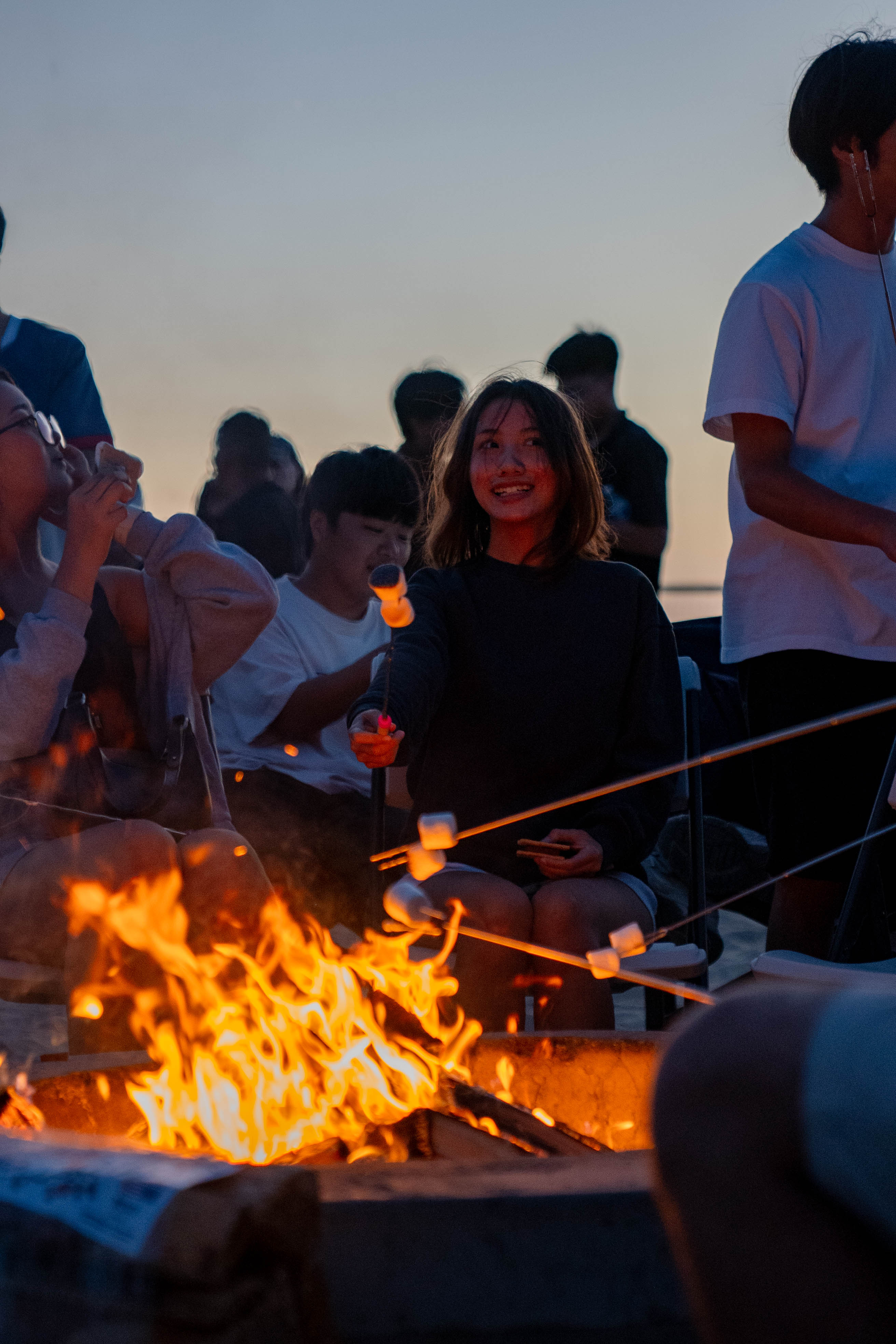 Group of IEC students roasting s'mores