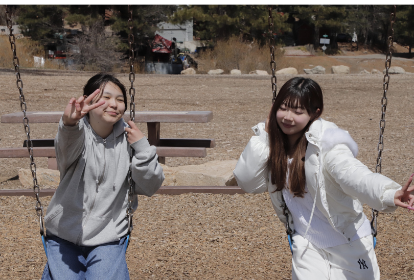 Two IEC students sitting on the swing in Big Bear