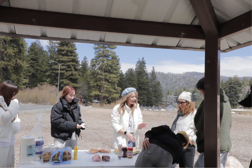 Group of IEC students and teacher making sandwich in Big Bear