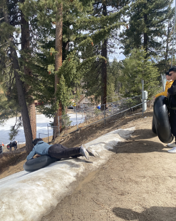 IEC student sliding down an icy hill