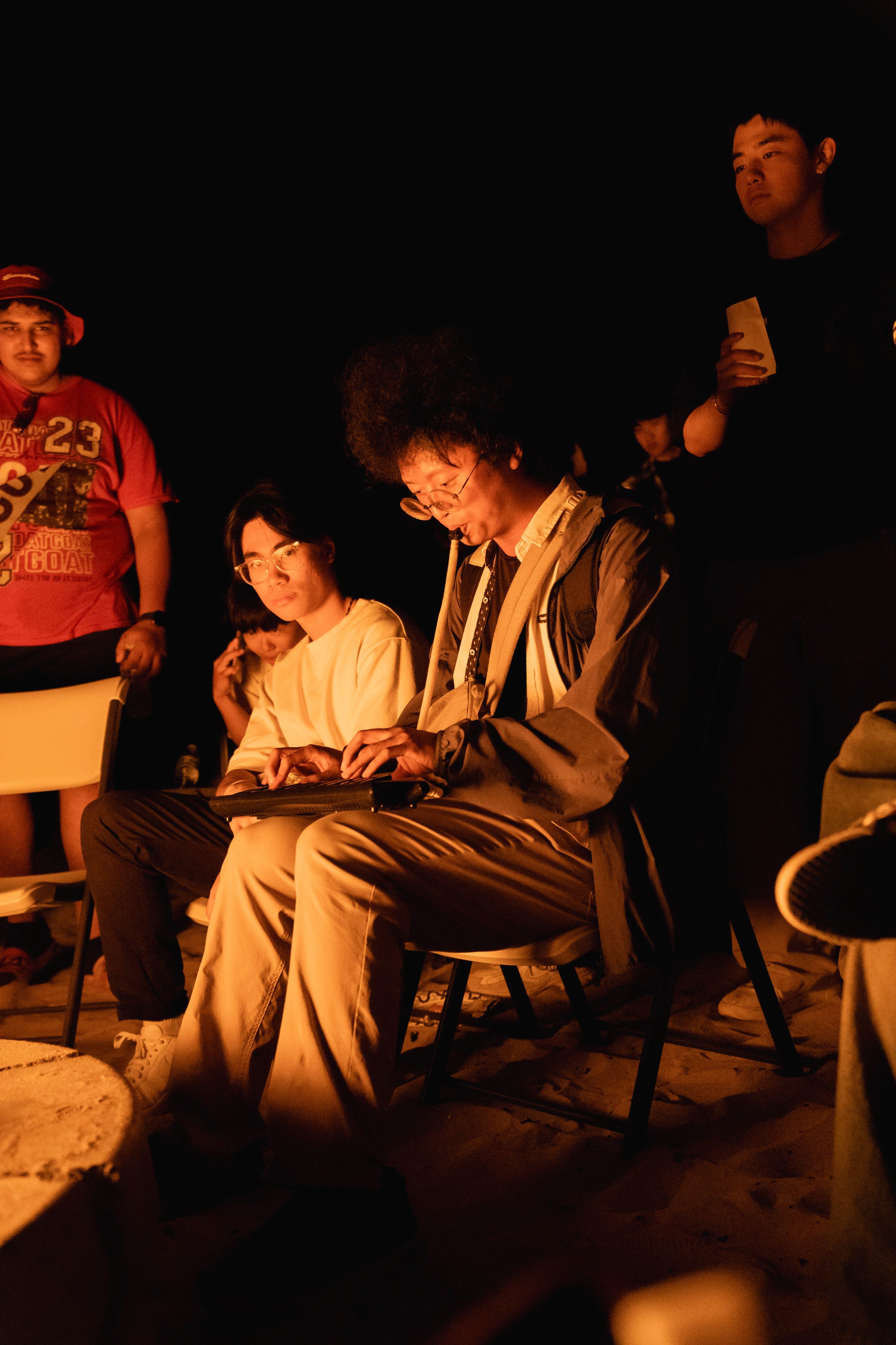 Student playing instrument by the fire