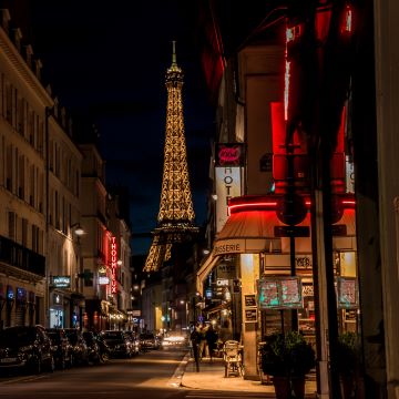 Night photo of street lights of Paris Cafe's with Eiffel tower in background