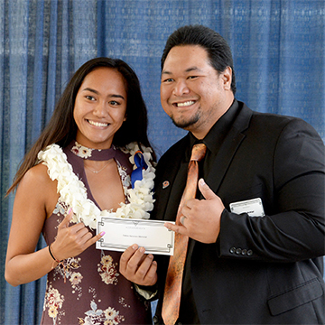 Donor and scholarship recipient holding a check