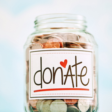 A jar filled coins with a 'donate' label in front.