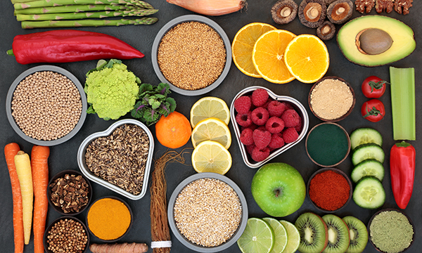 An assortment of fruit and vegetables laid out on the table.